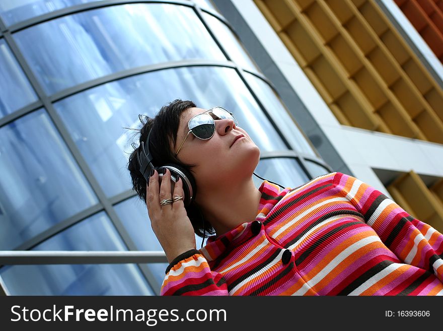 Attractive woman enjoying music outdoors