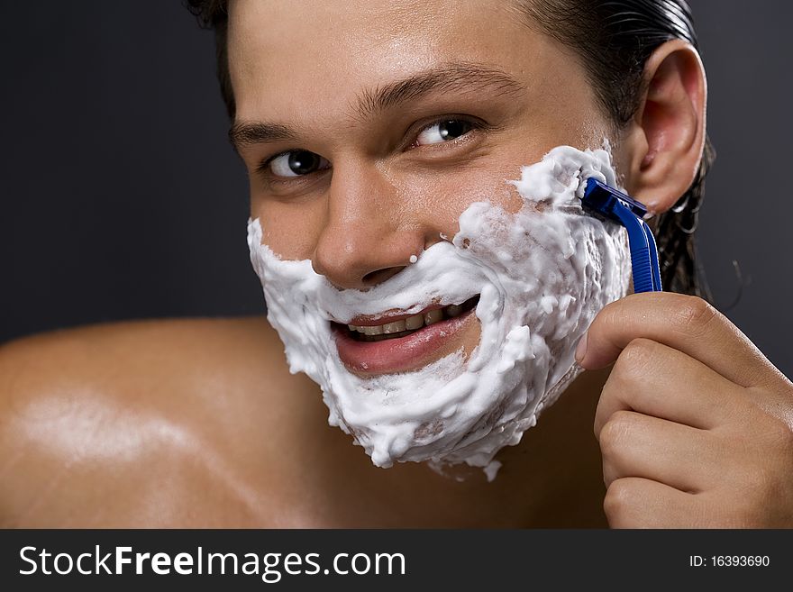 Handsome man shaving