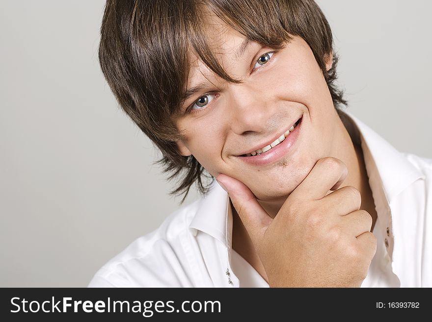 Closeup portrait of a charming young man smiling with copyspace. Closeup portrait of a charming young man smiling with copyspace