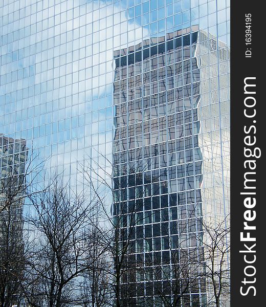 Skyscraper of glass in the reflection of glass house. Skyscraper of glass in the reflection of glass house