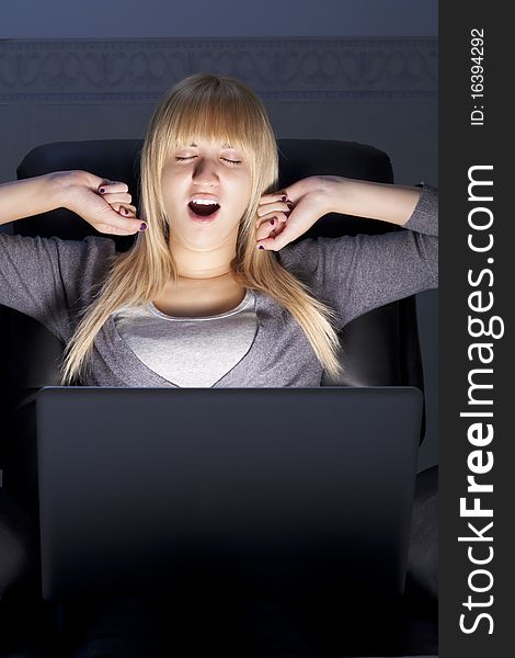 Yawning Woman with Laptop Stretching Her Arms