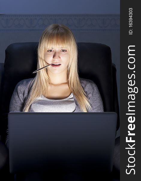 Blonde Woman with Laptop and a Pen inside Her Mouth. Blonde Woman with Laptop and a Pen inside Her Mouth