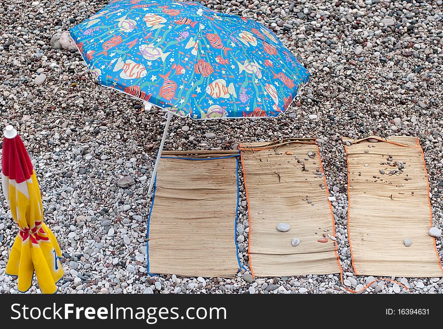 Empty place for sunbath on pebble beach