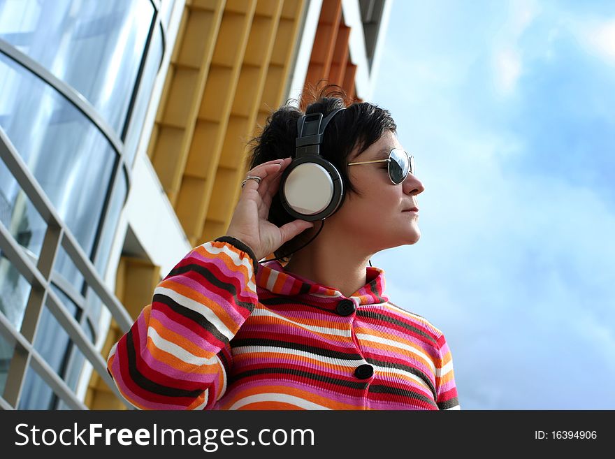 Attractive woman enjoying music outdoors
