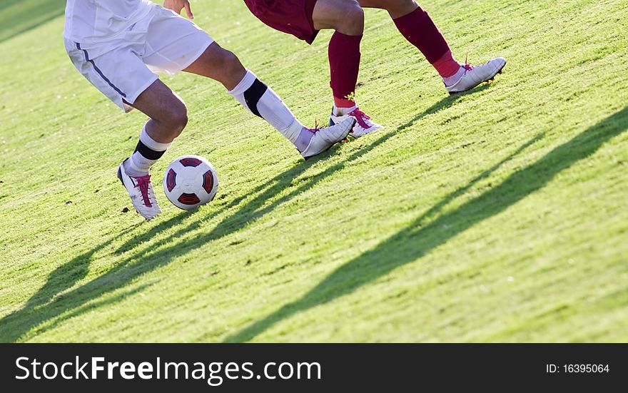 Soccer players running after the ball