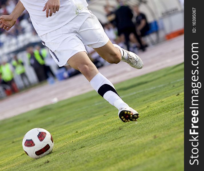 Soccer player running after the ball