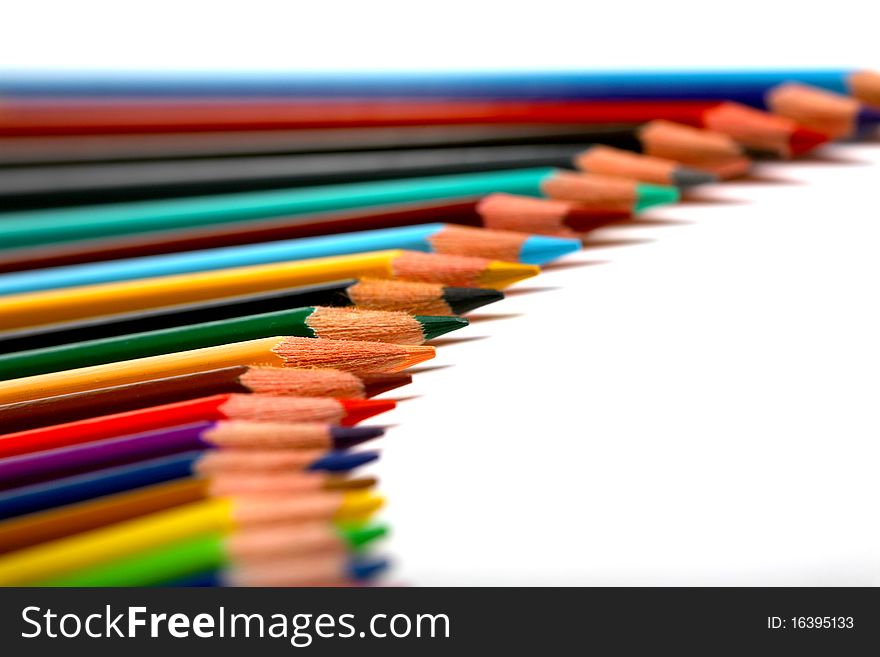 Colored pencils forming a line with a white background. Colored pencils forming a line with a white background