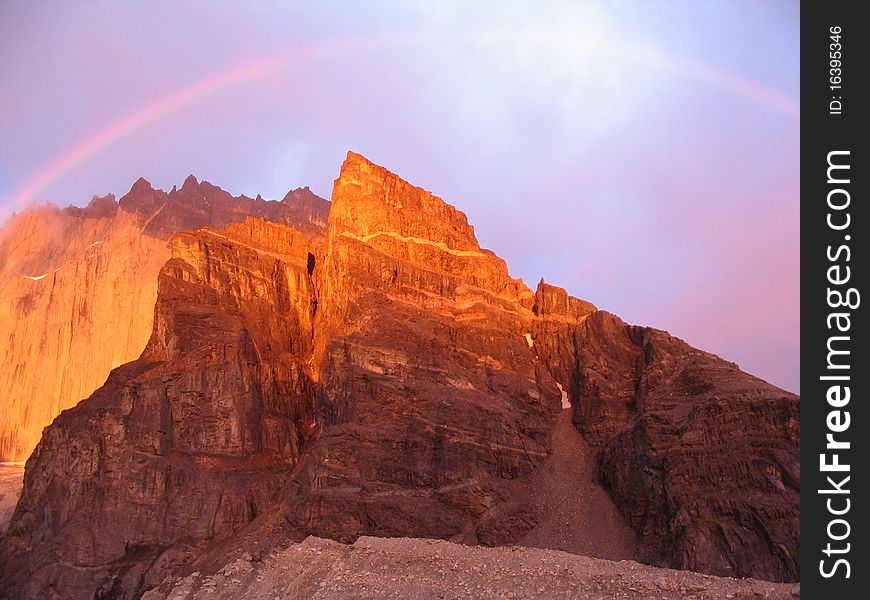 During sunrise, there was a little bit of rainfall, ending in a magnificent sunrise, right, on the peak of Los torres del Paine. During sunrise, there was a little bit of rainfall, ending in a magnificent sunrise, right, on the peak of Los torres del Paine