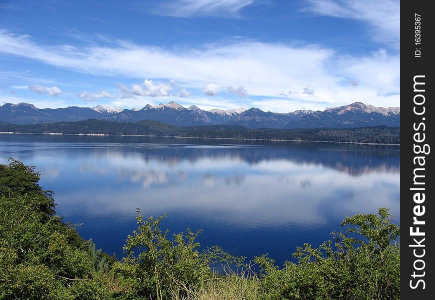 A beautiful mountain skyline mirrored on a lake. A beautiful mountain skyline mirrored on a lake