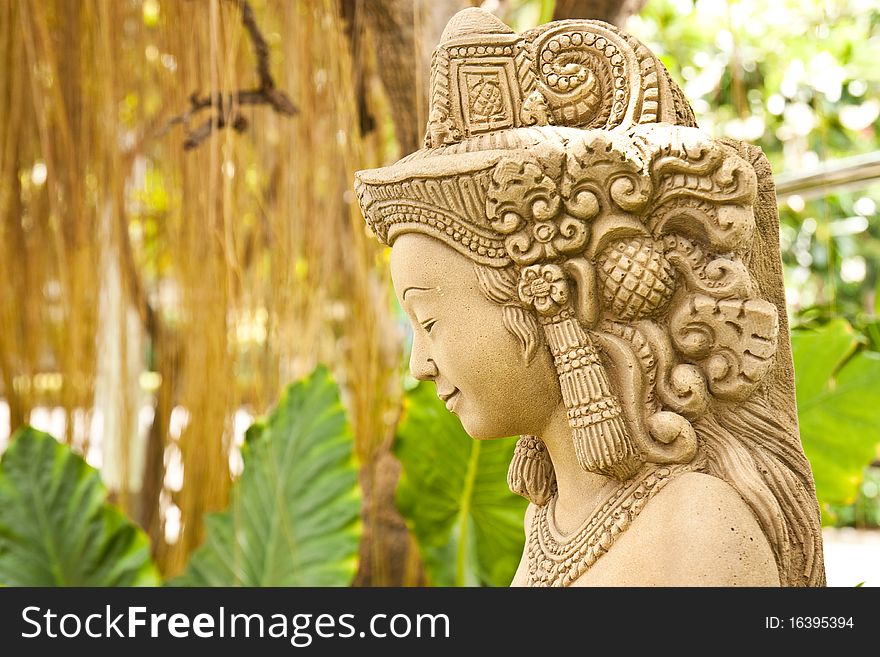 Thai female stone sculpture in the garden