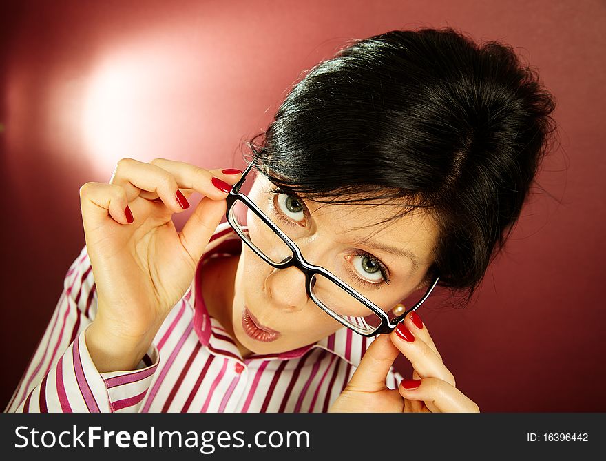 Nerdy office woman over bordeaux background looking ecstatic. Nerdy office woman over bordeaux background looking ecstatic