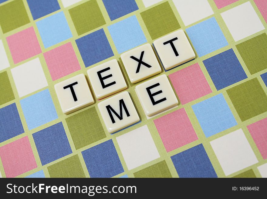 The words 'text me' in a colorful block background. The words 'text me' in a colorful block background.