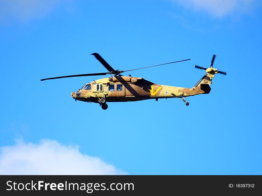 A military Helicopter on a blue sky background.
