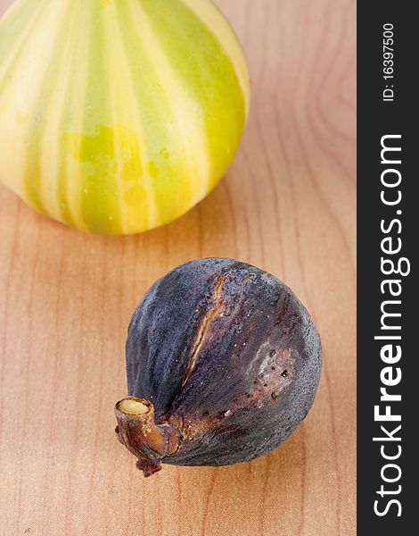 Ripe fruits of a fig on a wooden table.