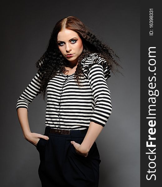 Beautiful fashion woman in stripy top with creative make-up posing. Beautiful fashion woman in stripy top with creative make-up posing