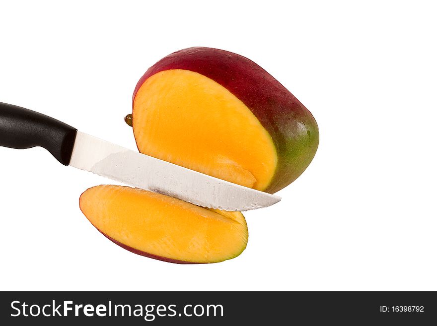 Mango slice with knife on white background.