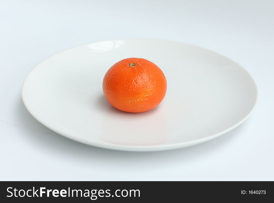 Oranges shot on a white plate