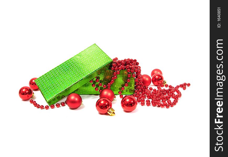 Red Christmas balls in green box on white background
