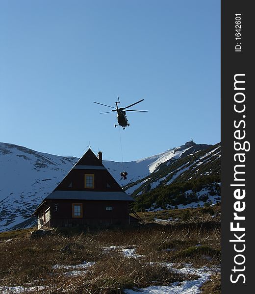 Emergency helicopter near carpathian mountains in winter