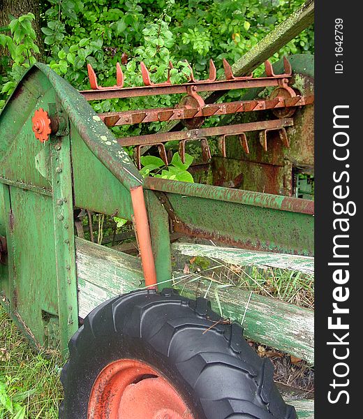 A piece of farm equipment on a horse farm.