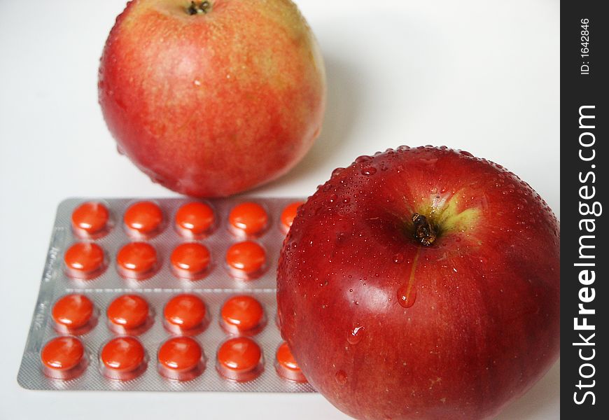 Two red apples and tablets