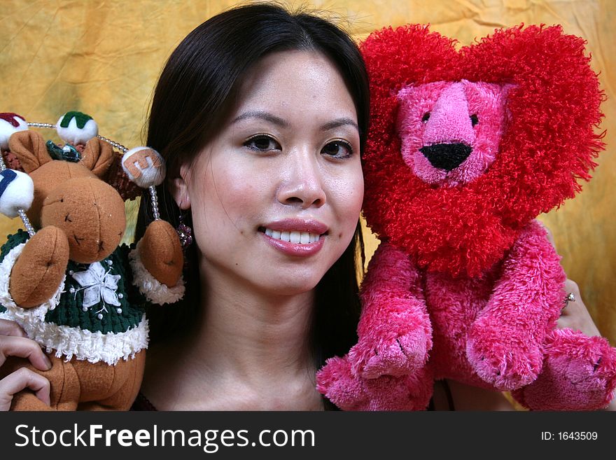 An Asian girl and stuffed animals.