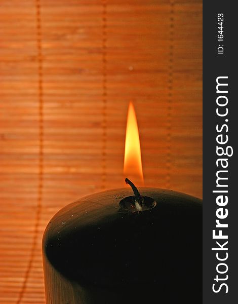 A candlelight on a bamboo background