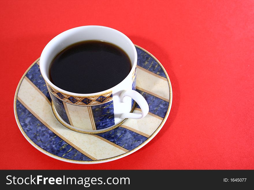Coffee cup and saucer on red table. Coffee cup and saucer on red table.