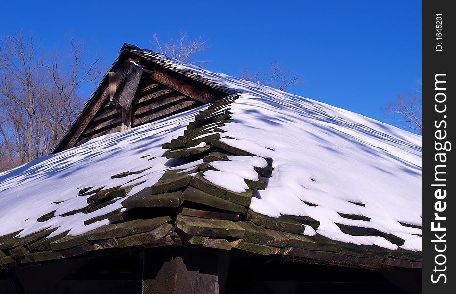 The roof of a lodge in winter topped with snow. The roof of a lodge in winter topped with snow