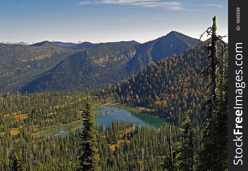 This image of the alpine lake surrounded by the golden color of the tamaracks was taken in western MT. This image of the alpine lake surrounded by the golden color of the tamaracks was taken in western MT.