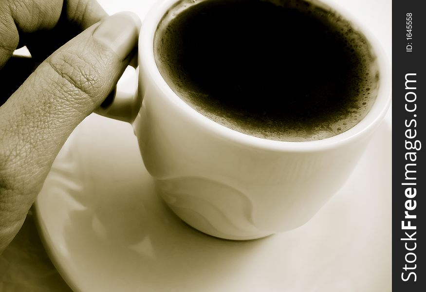A cup of black coffee kept by a woman in old black and white tonality