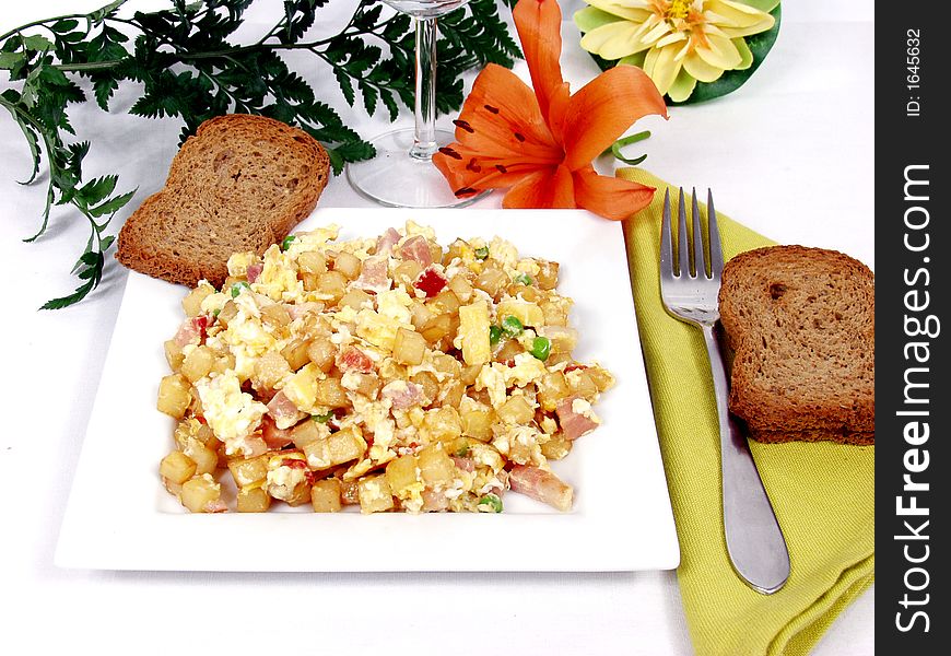 A plate of creamy scrambled eggs with toast bread