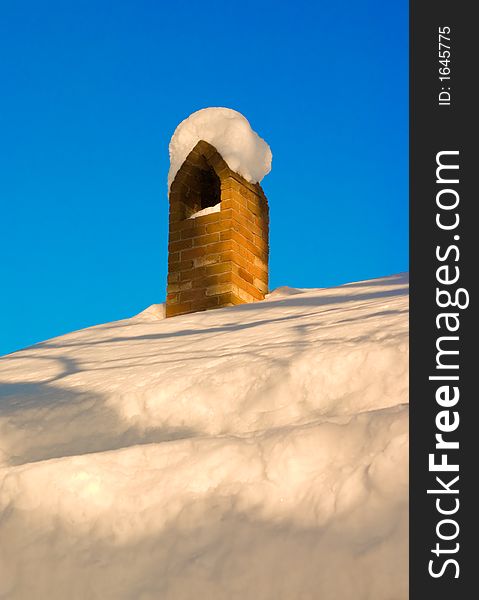 Chimney that is covered in snow. Chimney that is covered in snow