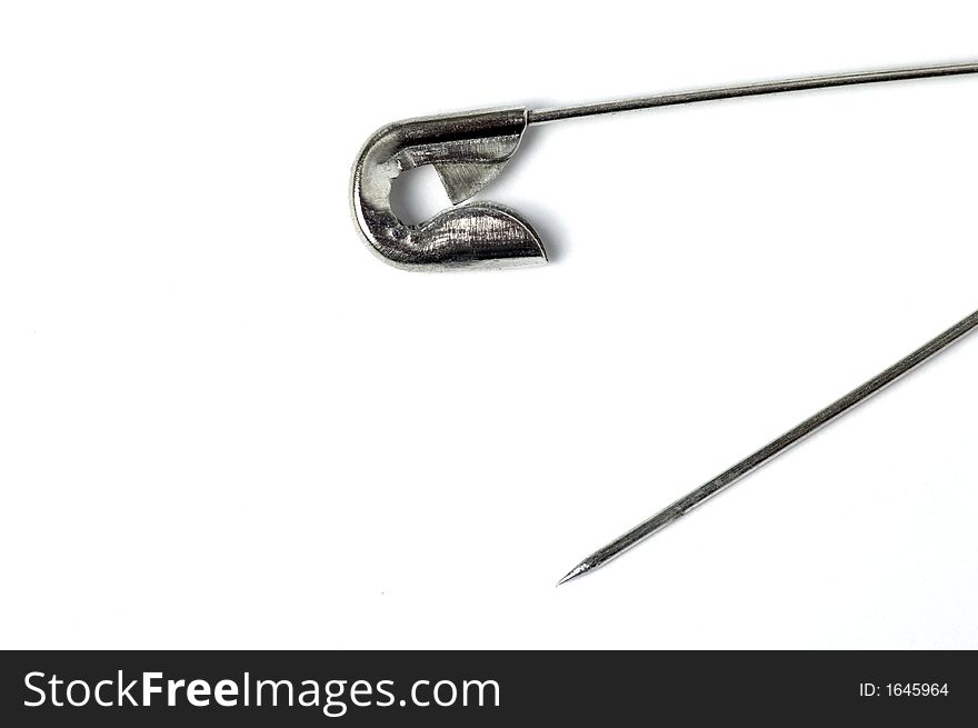 Open safety pin isolated on white background