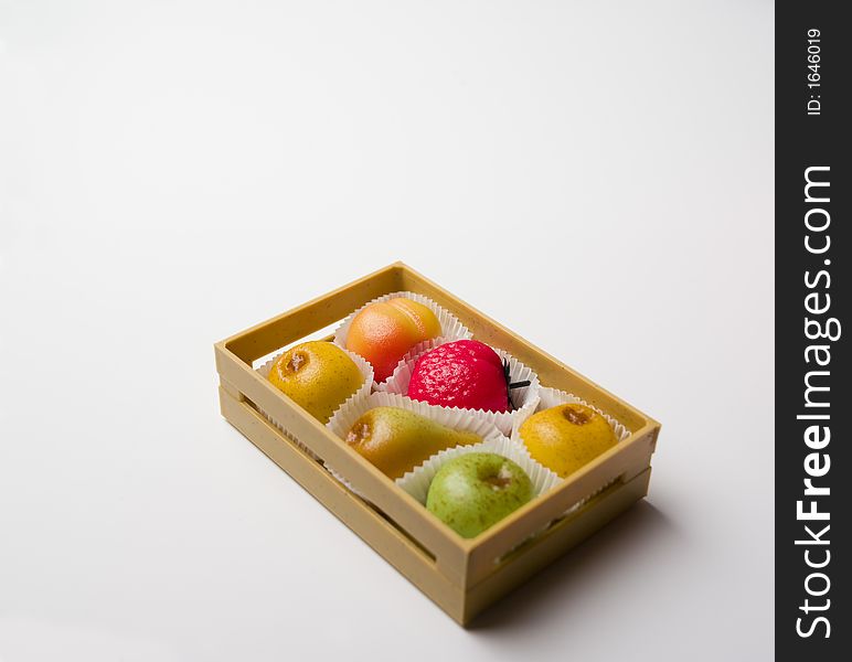 Crate with sweet candies shaped as fruit. Crate with sweet candies shaped as fruit.