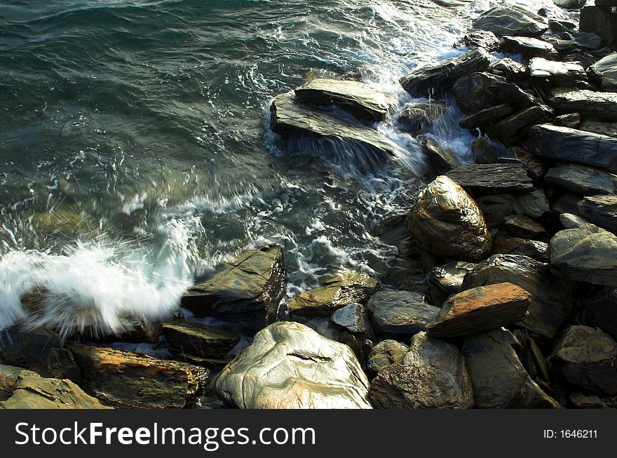 Rocky shoreline with waves from the ocean crashing over them. Rocky shoreline with waves from the ocean crashing over them