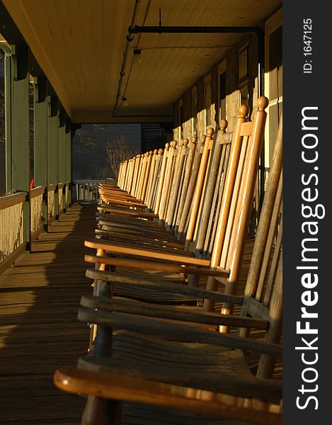 Row of rocking chairs on the porch of an inn. Row of rocking chairs on the porch of an inn