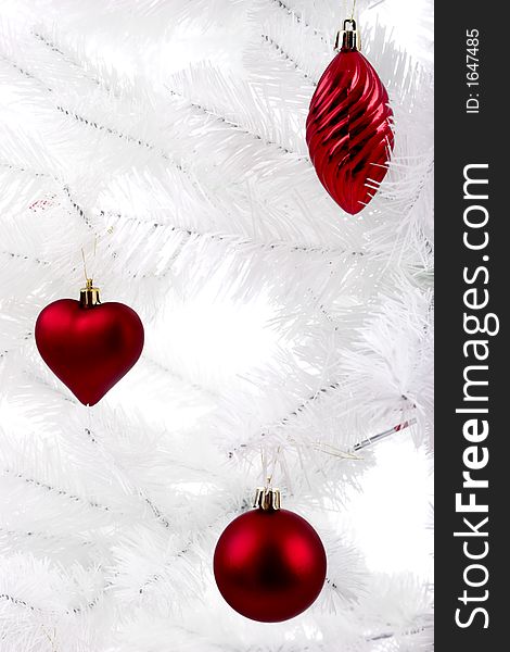 Christmas ornaments hanging from a white tree