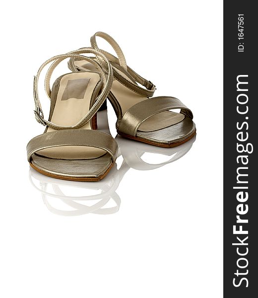 Beautiful feminine sandals on white with reflection