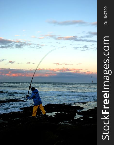 Fisherman casting his bait into the horizon. Fisherman casting his bait into the horizon