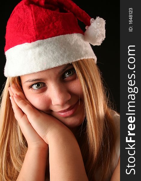 Gesticulated Christmas blonde girl like reposing, black background. Gesticulated Christmas blonde girl like reposing, black background