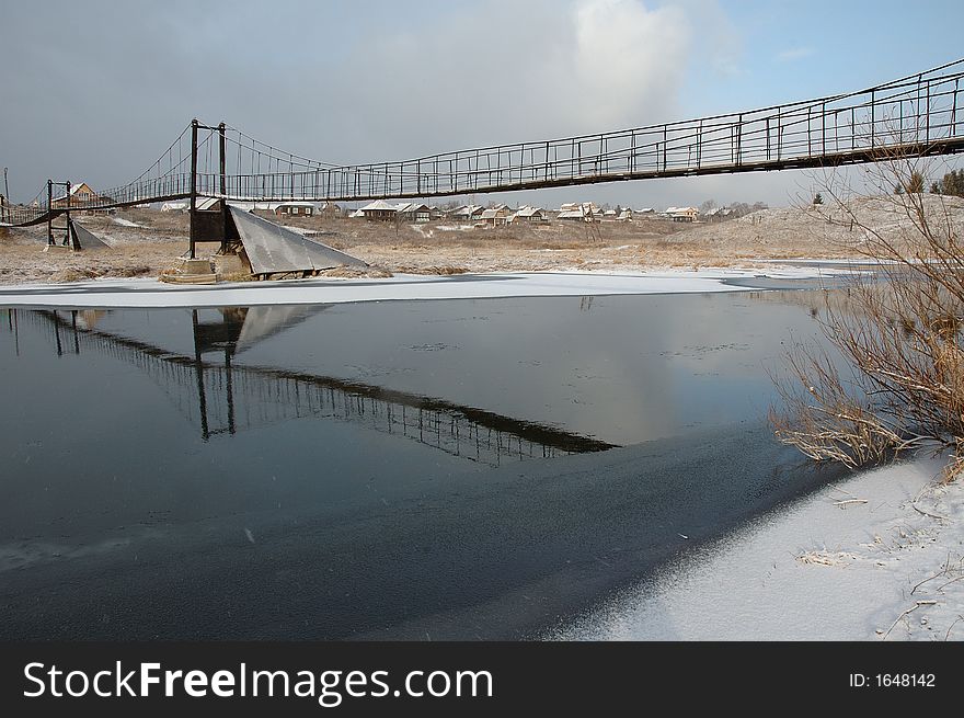 View of bridge over winter river. Russia.