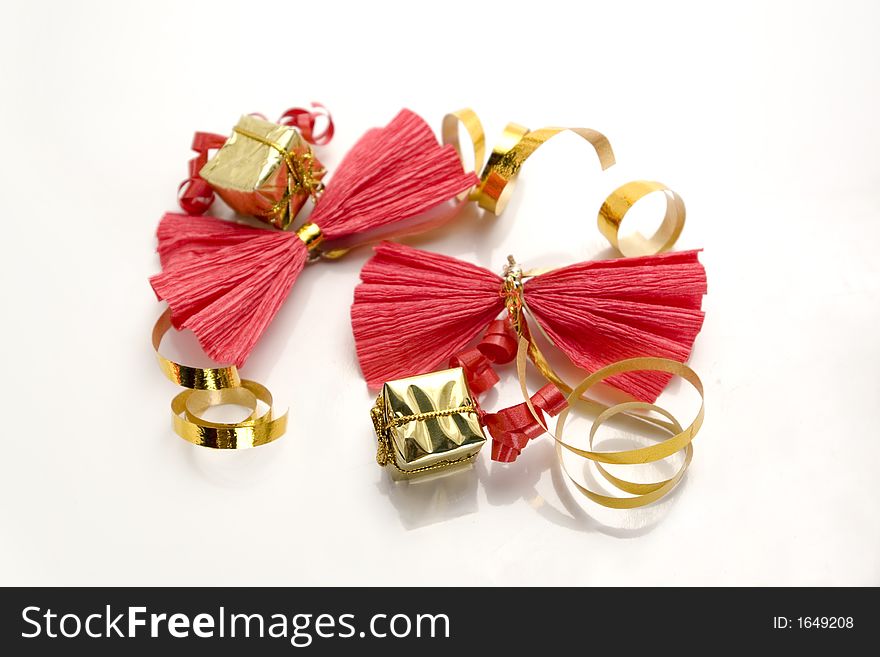 Red paper ribbons tied with golden bands with little golden presents for christmas party. Red paper ribbons tied with golden bands with little golden presents for christmas party