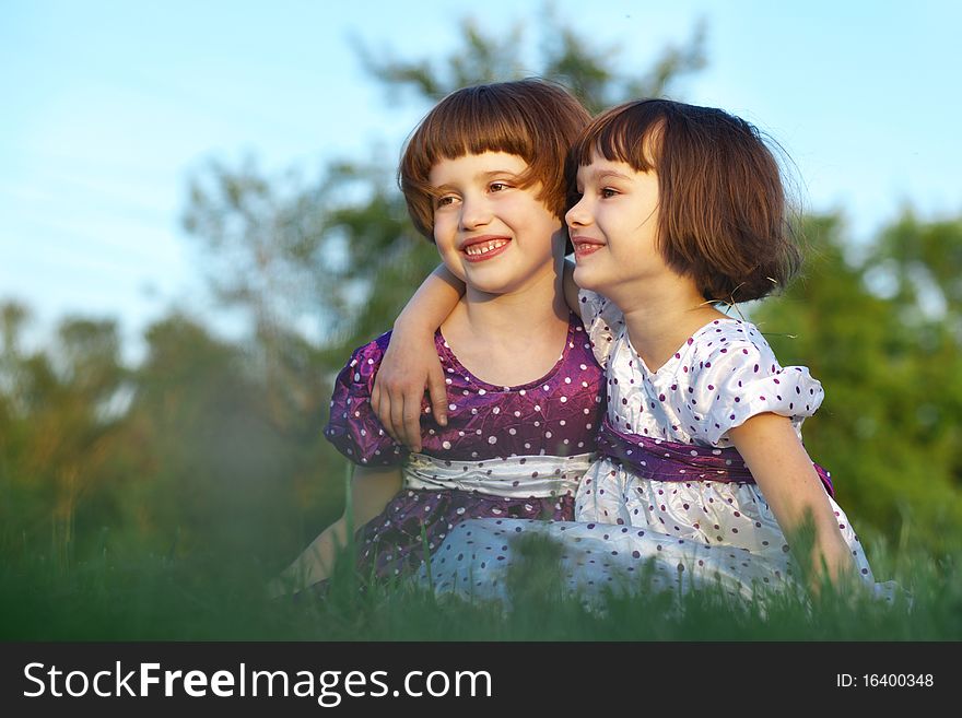 Two little friends sitting on grass. Two little friends sitting on grass