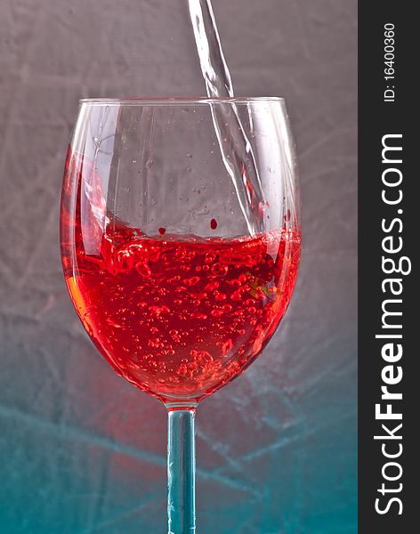 Clear Liquid Becoming Red in Wine Glass. Clear Liquid Becoming Red in Wine Glass