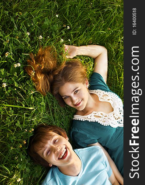 Happy young couple lying on grass. Happy young couple lying on grass