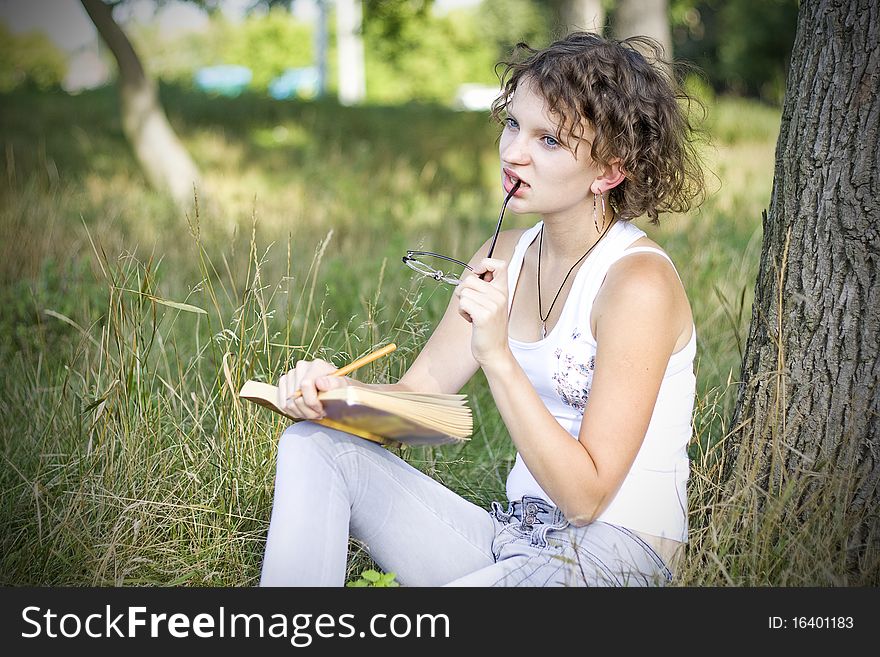 Girl reding book in park. Girl reding book in park