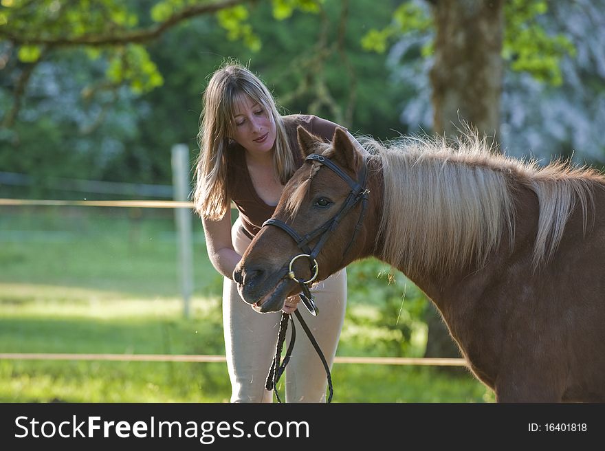 Woman bonding and being affectionate with shetland pony. Woman bonding and being affectionate with shetland pony