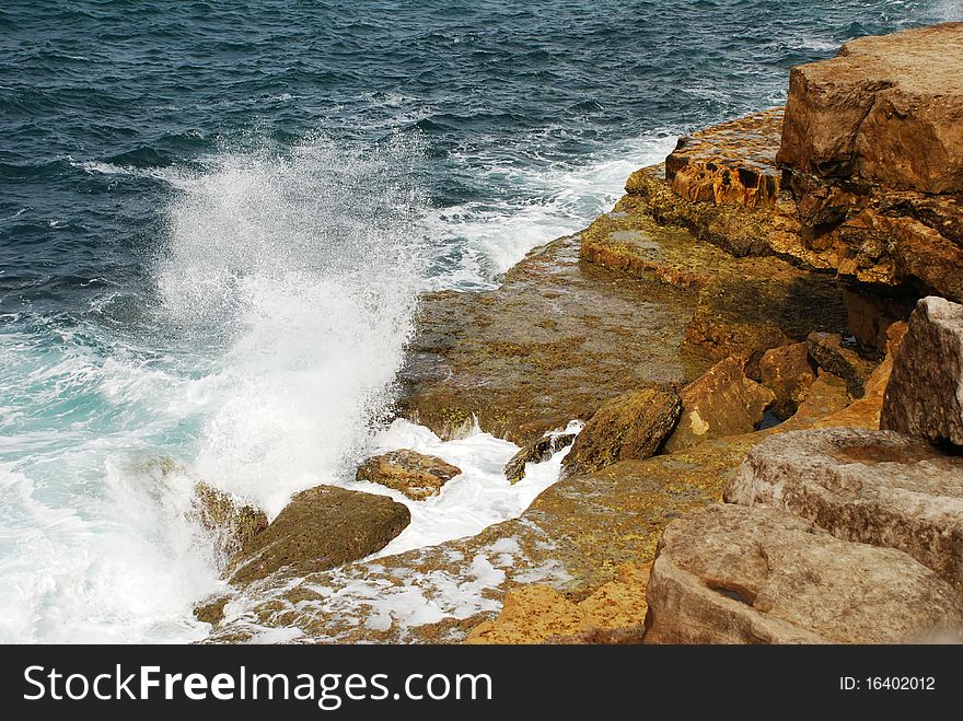 Fierce waves splash against the rocky coast of Weymouth. Fierce waves splash against the rocky coast of Weymouth