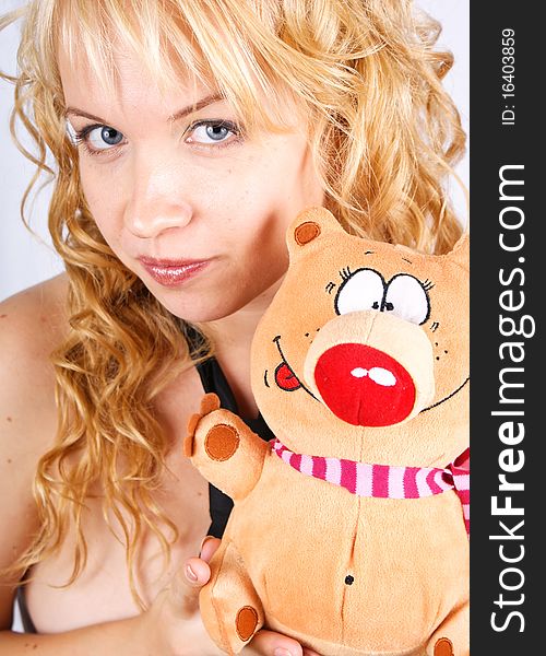 Pretty blond girl with toy